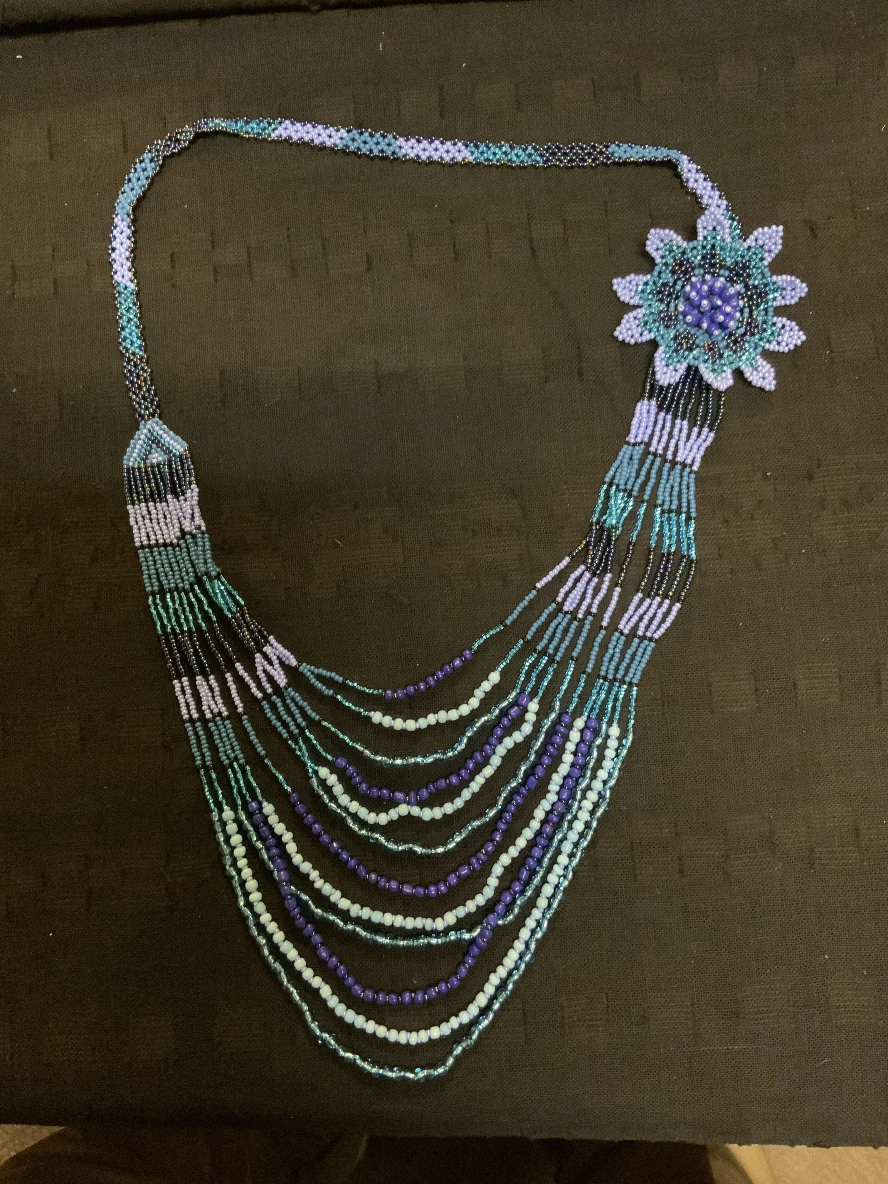 Guatemalan handcrafted glass bead bib style necklace. 24” neck, total length 36”.